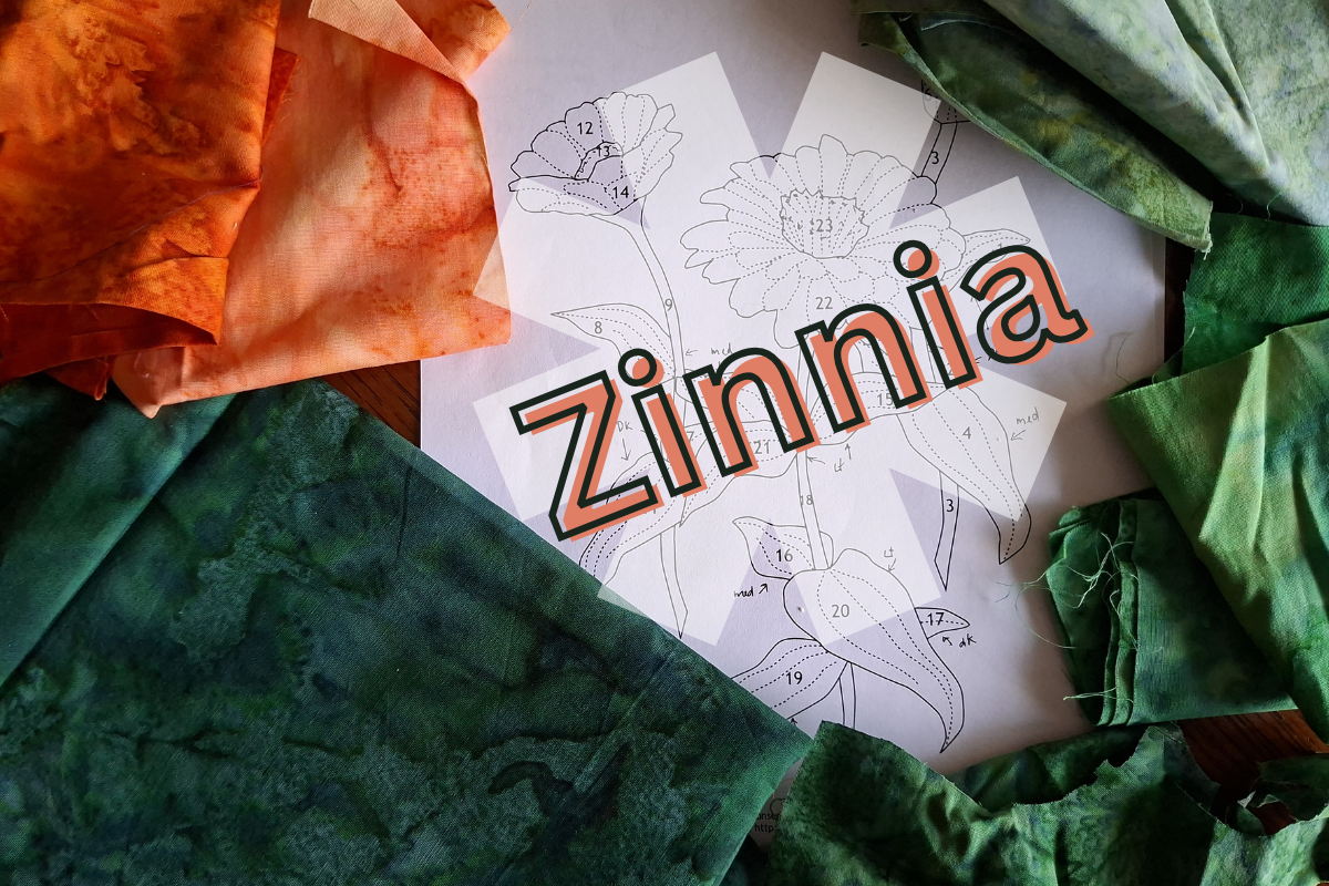 Zinnia fabric swatches and pattern paper on a table