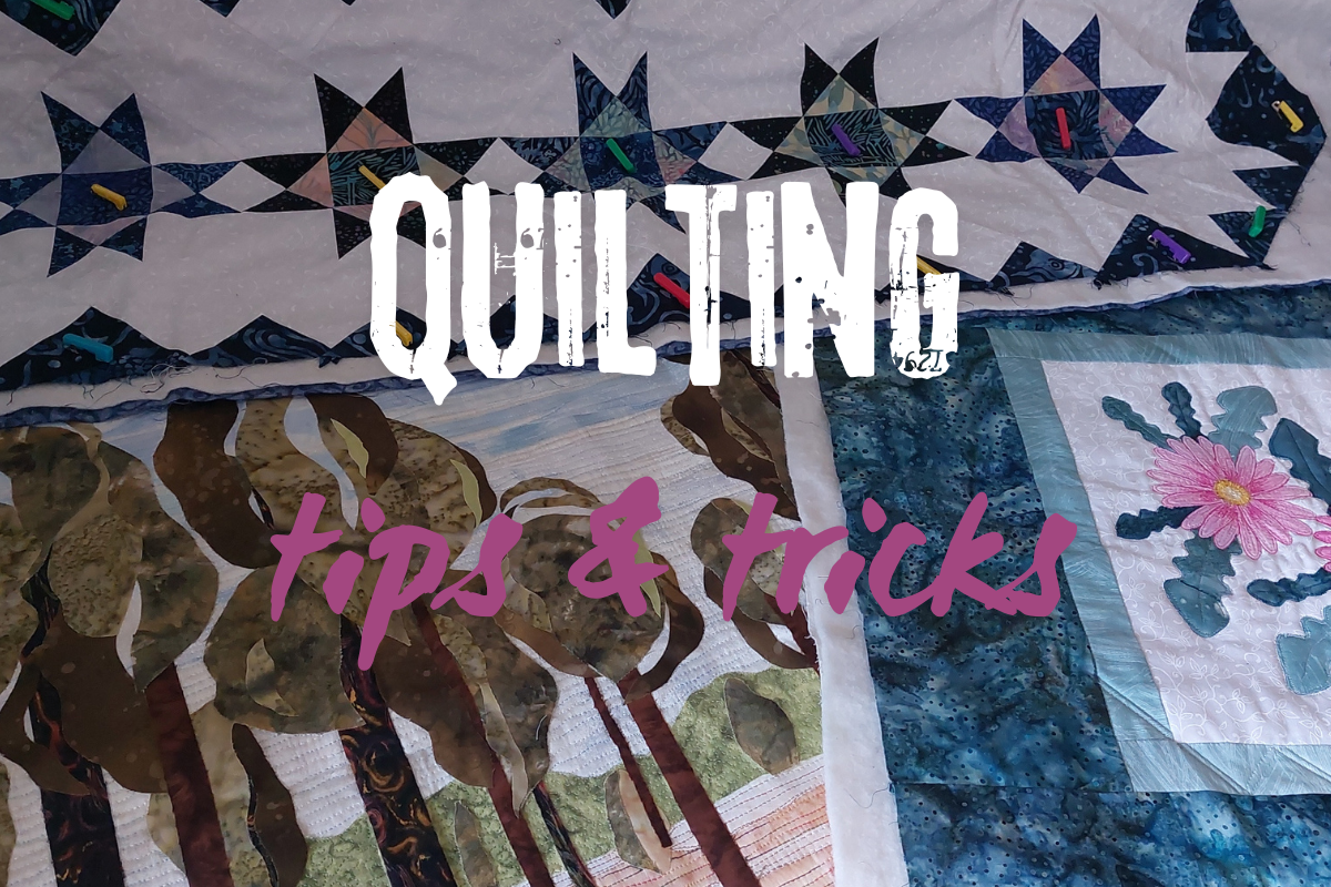 Quilt with various patterns and colors, featuring the text 'QUILTING tips & tricks' in the center.